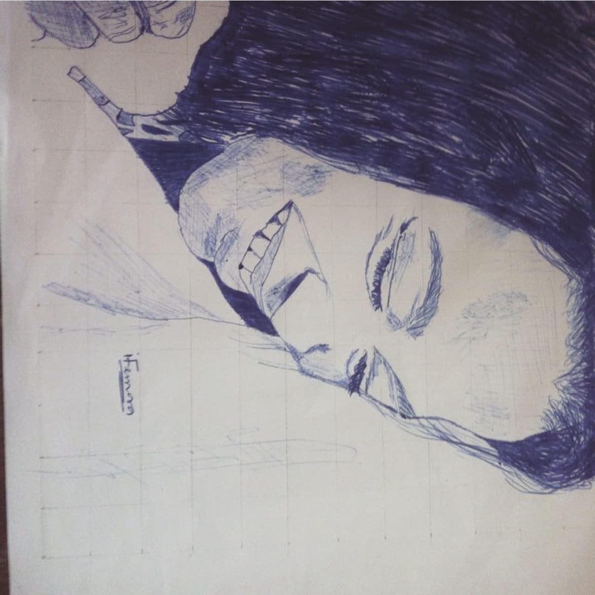 A blue ballpoint pen portrait sketch on gridded paper