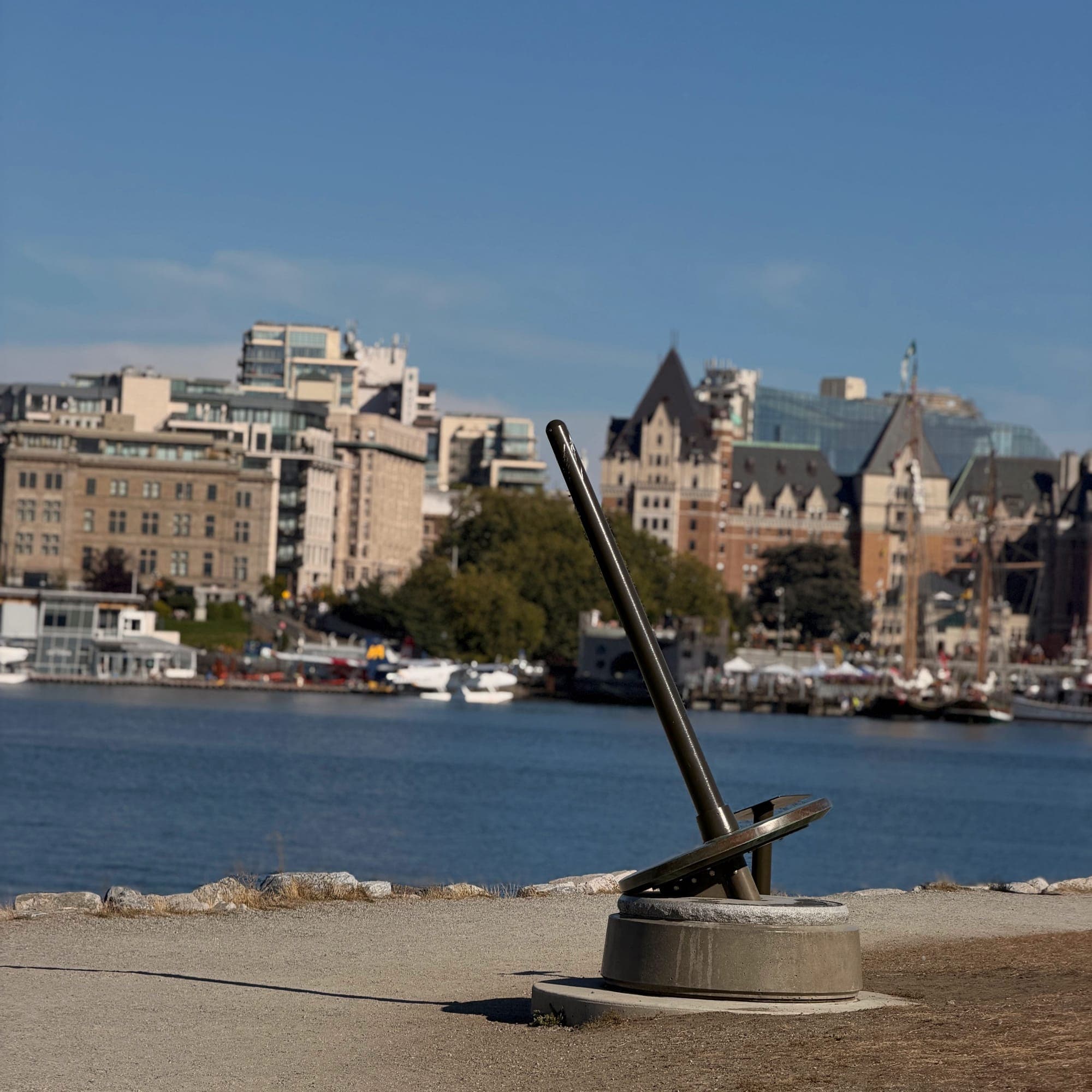 An anchor sculpture on the causeway with the Empress Hotel and harbour buildings behind
