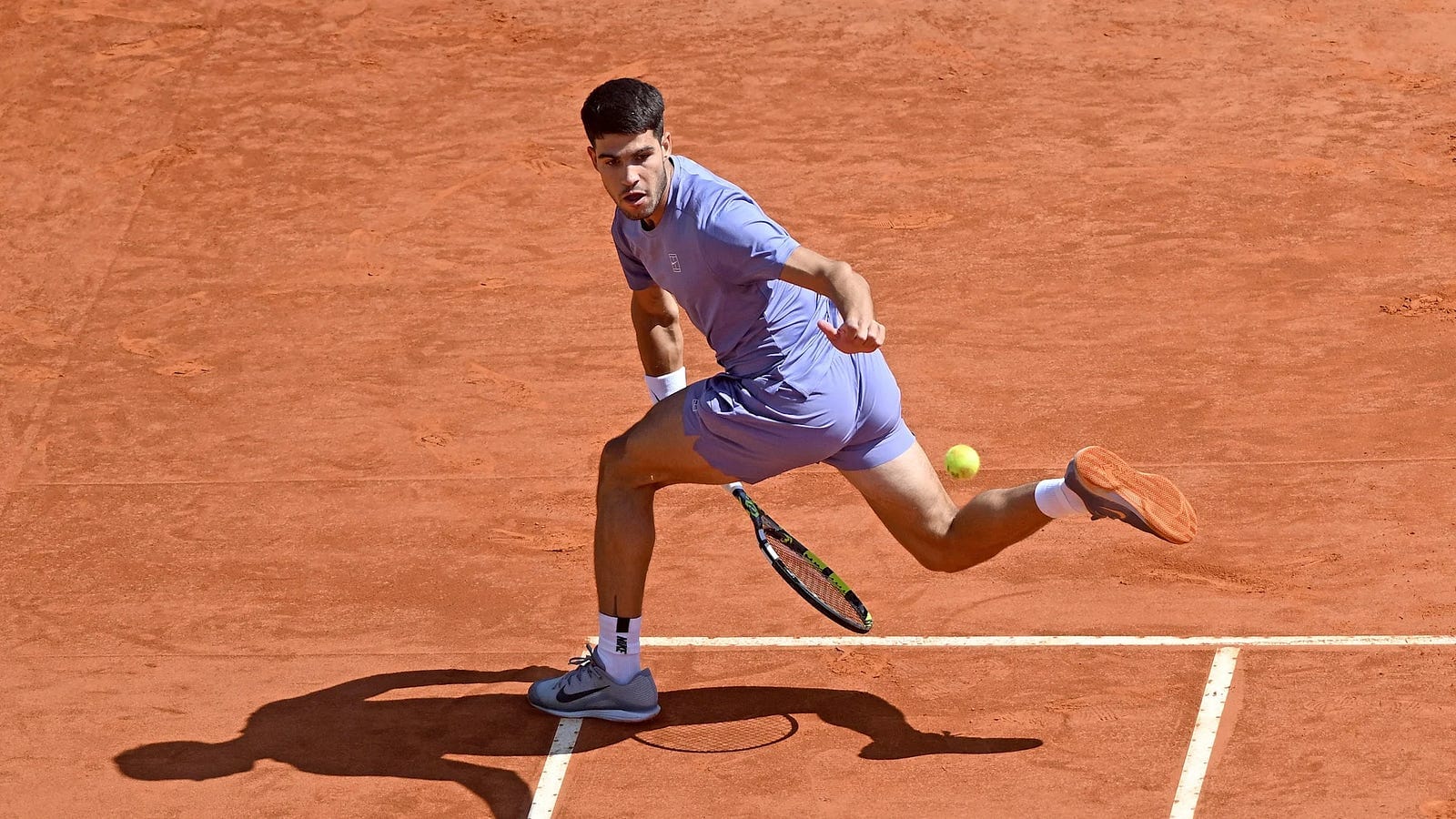 Carlos Alcaraz incredible running tweener at Monte Carlo Masters. Shot of the year 2025. Source: si.com